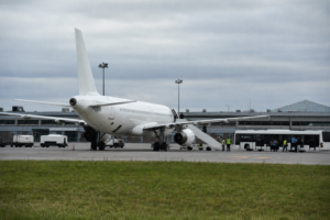 White narrow-body aircraft at a remote stand at a secondary European airport